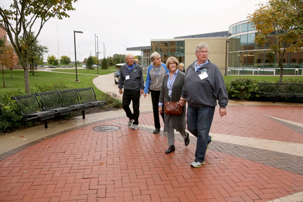 Class of '68 walks outside the Fieldhouse into Kindschi Hall.